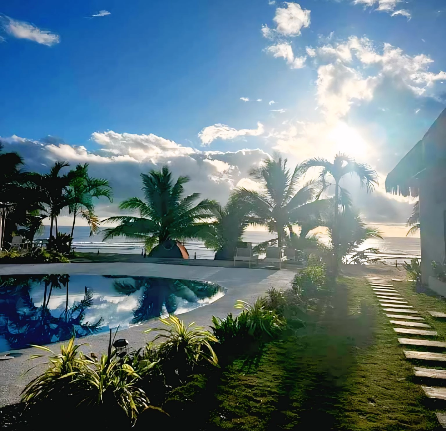 Sun and Waves Resort pool and beach with coconut trees.